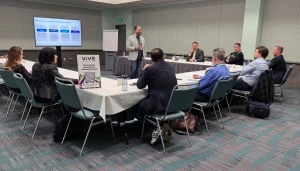 Harsh Singh speaking with healthcare executives in a consulting session at an event